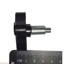 Load image into Gallery viewer, Black wingnut with a metal screw on a white background with a ruler for scale.
