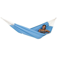Load image into Gallery viewer, Woman relaxing in a blue hammock with white straps on a white background
