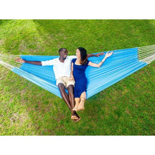 Load image into Gallery viewer, Two people relaxing in a blue hammock on a grassy field
